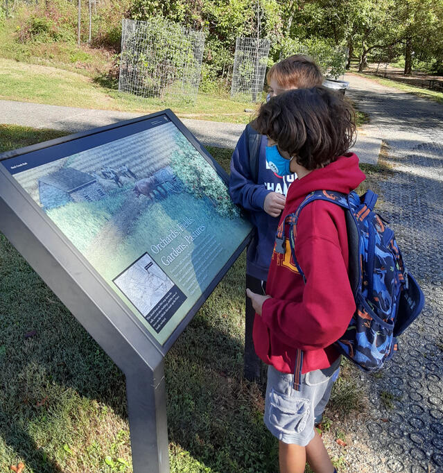 Students learning about the history of Peirce Mill.